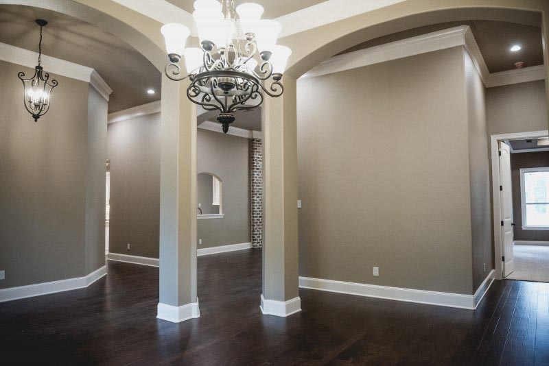 Chandeleir Arched openings in this open Formal Dining Room
