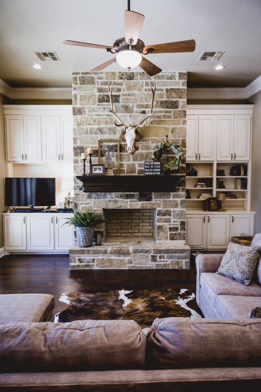 Wood burning Stone Fireplace and Painted cabinets with Wood floors
