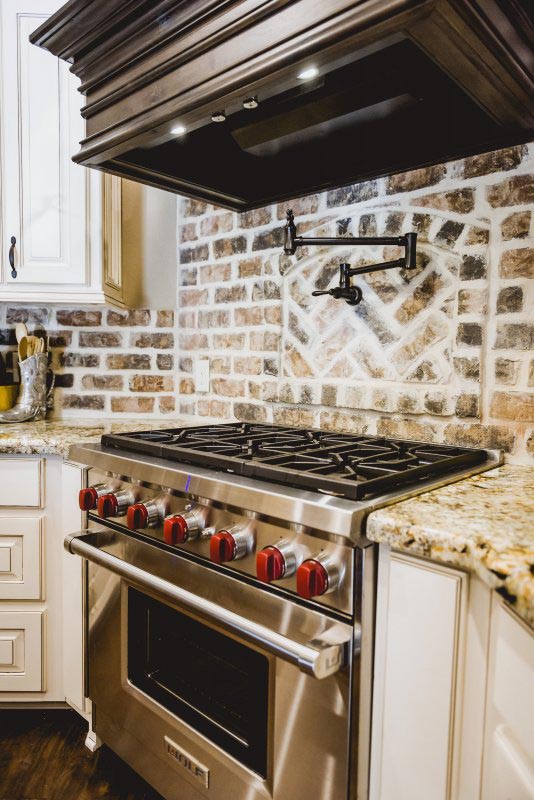 Wolf Brand Gas Range with Custom brick Accent Wall and Pot Filler